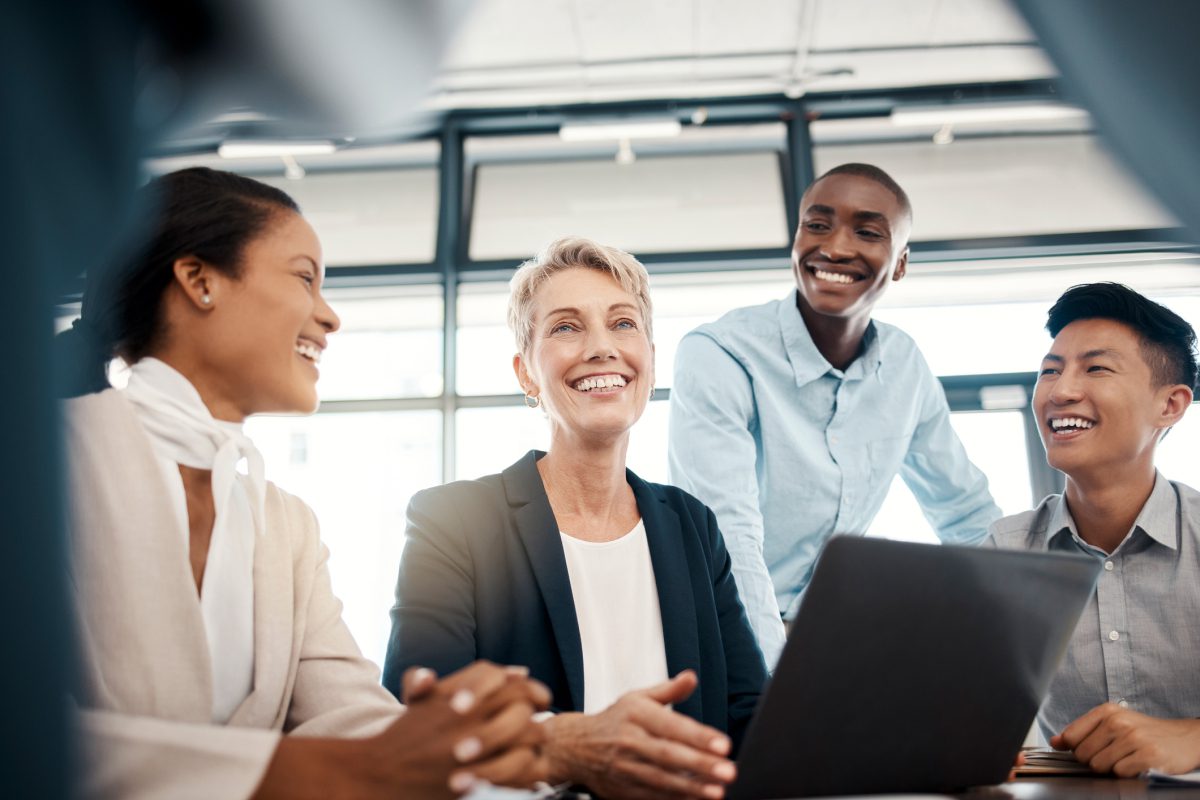 Group of colleagues smiling during meeting.